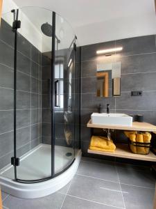um banheiro com chuveiro e pia em Apartmány Havířská Žacléř, Krkonoše em Žacléř mais 47 fotografias