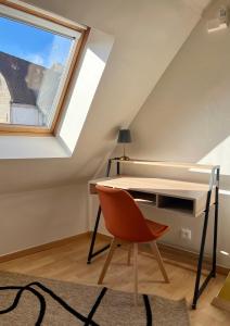 ein Dachbüro mit Schreibtisch und Fenster in der Unterkunft Maison 2 chambres avec bureau - Proche gare in Saint-Omer + 7 Fotos