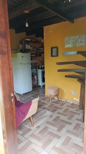- une cuisine avec un réfrigérateur et une chaise dans la chambre dans l'établissement Chalédri, à Chapada dos Guimarães