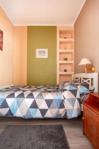 a bedroom with a bed with a checkerboard pattern at Old town apartment in Pärnu