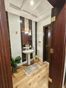 a bathroom with a sink and a mirror at comfort suite in Jeddah