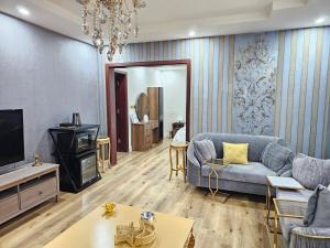 a living room with a couch and a tv at comfort suite in Jeddah