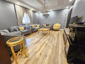 a living room with couches and a table at comfort suite in Jeddah +3 photos