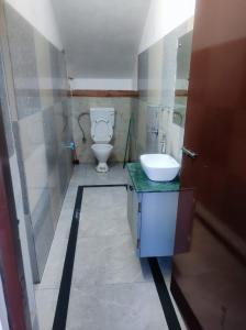 a bathroom with a toilet and a sink at GoFam in Dibrugarh