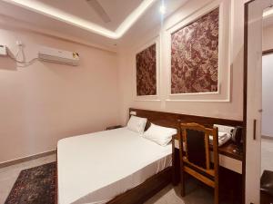 a small bedroom with a white bed and a window at Hotel Shri Ram Anadam Inn in Masodha +5 photos