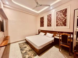 a bedroom with a bed and a television in it at Hotel Shri Ram Anadam Inn in Masodha
