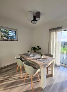 a dining room with a wooden table and chairs at Panorama trifft Gemütlichkeit in Nümbrecht