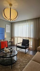 a living room with a couch and a chair at Oro Inn in Buraydah