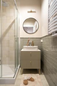 a bathroom with a sink and a mirror at Red Roof Apartments Old Town in Krakow