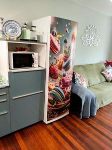 eine Küche mit einer Mikrowelle und einem Sofa im Zimmer in der Unterkunft Flor de Lis in Medina de Pomar