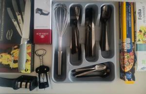 a utensil tray with utensils and other kitchen utensils at Przytulny Kąt in Żory
