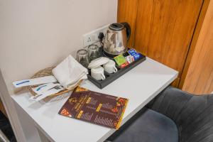 a table with a coffee pot on top of it at Hotel Deol's Paradise in Indore