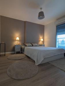 a bedroom with a large bed with two rugs at "Olympic Sweet Home" Paris Stade de France in Épinay-sur-Seine