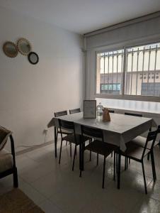 a dining room with a table and chairs and a window at Piso los franchutes in Cabra +18 photos