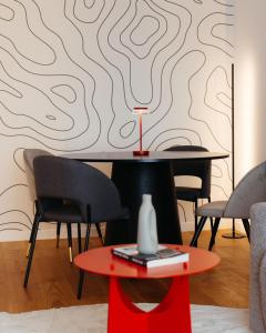 a table and chairs in a room with a wall at Campus - Palas Moonlight in Iaşi