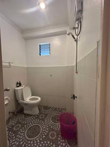 a small bathroom with a toilet and a window at Dean's Homestay Siargao in General Luna