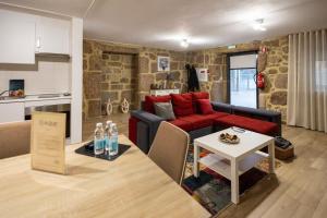 a living room with a couch and a table at Alqueiturismo - Casas de Campo in Guarda