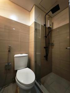 a bathroom with a toilet and a shower at Sithonia Suite, Shore Residences Tower C near MOA in Manila