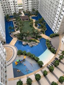 an overhead view of a pool in a city with tall buildings at Sithonia Suite, Shore Residences Tower C near MOA in Manila +9 photos