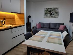 a kitchen and a living room with a table and a couch at Friends 2 Vlašić in Vlasic