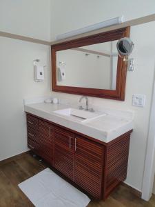 a bathroom with a sink and a mirror at La Salamandre Paraty in Paraty