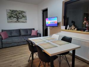 a living room with a table and a couch at Friends 2 Vlašić in Vlasic