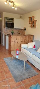 a living room with a couch and a table at Studio Isola 2000 in Isola 2000