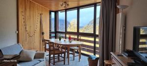 a dining room with a table and a large window at Studio Isola 2000 in Isola 2000