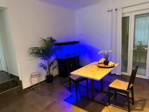 a dining room with a table and a blue light at Sweet Dream House in Brussels