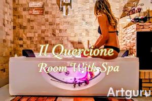 a woman sitting in a bathtub in a room with spa at "Il Quercione" Room With SpA in Lama Di Peligni