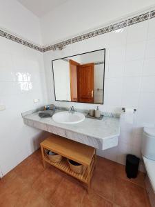 a bathroom with a sink and a mirror at Villa Catamaran Rubicon piscina privada cerca del mar in Playa Blanca +27 photos
