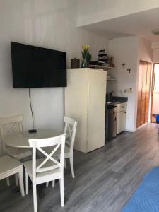 a living room with a table and chairs and a kitchen at Cadaques caribe bayahibe in La Laguna +16 photos