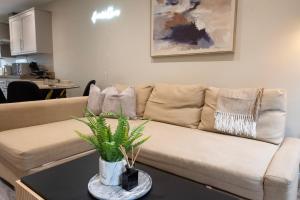 a living room with a couch and a table at Stylish 2BR Retreat - Sleeps 6 - Central Chatham in Chatham
