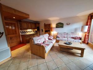 a living room with two couches and a coffee table at Les Airelles A21 in Les Menuires +15 photos