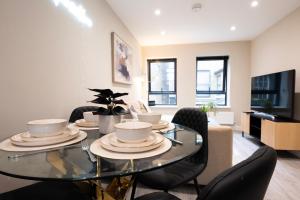 a dining room with a glass table and chairs at Stylish 2BR Retreat - Sleeps 6 - Central Chatham in Chatham