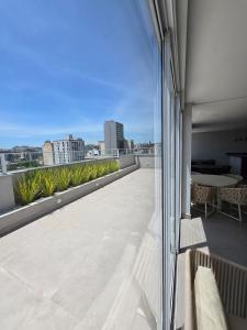 a balcony with a view of a city skyline at Polo NEXT Studios in Volta Redonda