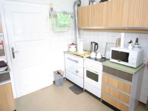 a small kitchen with a stove and a microwave at Ferienhaus in Scheifling nahe Skipisten in Scheifling