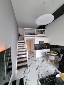 - un escalier blanc dans une chambre avec une table dans l'établissement Apartments by Radecka Zarembowicza Wrocław Lotnisko, à Wrocław