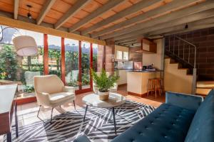 a living room with a couch and a table at Asali Lodge in East London