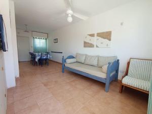 a living room with a blue couch and chairs at Las Grutas Star in Las Grutas