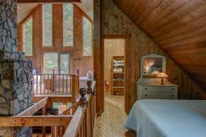 a bedroom with a bed in a wooden cabin at Hidden Creek Cabin in Fleetwood