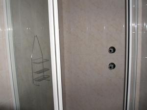 a shower with two shelves in a bathroom at Sea Why in Natureʼs Valley +18 photos