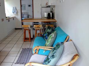 a living room with a couch with pillows on it at Sea Why in Natureʼs Valley