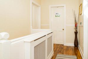 a white room with a fireplace and a mirror at Luxury 4BR, Free Parking, Near Beach, Sleeps 8 in Edinburgh +68 photos