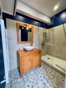 a bathroom with a sink and a mirror and a shower at Hotel LA PLACE in Saint-Amand-Montrond +37 photos