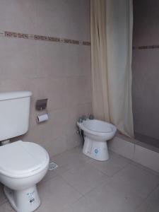 a bathroom with a toilet and a bidet at El cóndor in Balneario El Condor