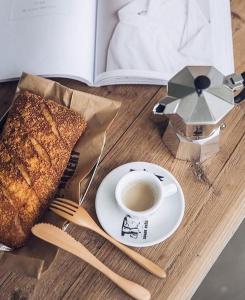 a table with a plate of toast and a cup of coffee at Rest Deluxe Hotel in Baku