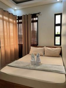 Postel nebo postele na pokoji v ubytování Mia Apartelle