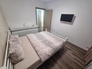 a hospital room with a bed and a television at Ezzely apartment ParkLake in Bucharest