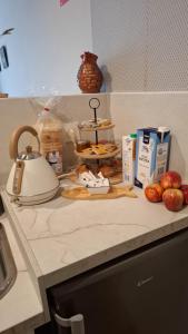 a kitchen counter with a tea kettle and food on it at ALTZOAN apartamentos Boutique & Parking in Zarautz